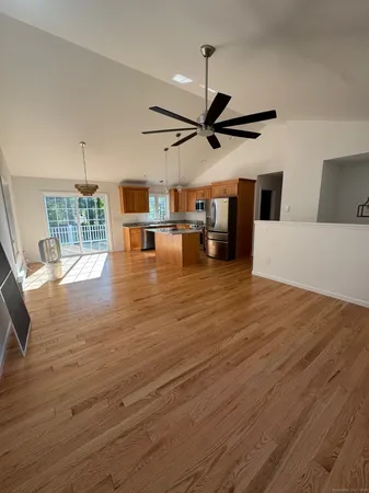 a view of a livingroom with wooden floor and furniture