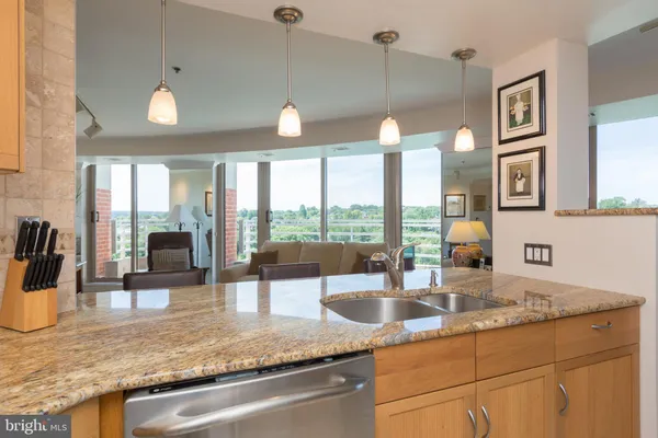 a kitchen with granite countertop a sink and a counter top space
