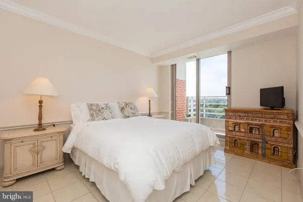 a bedroom with a large bed and flat screen tv