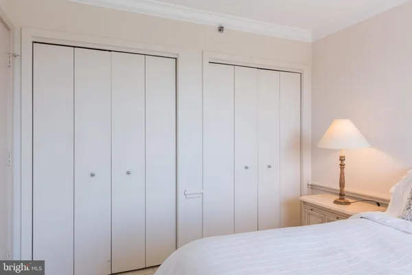 a bedroom with a bed and a lamp