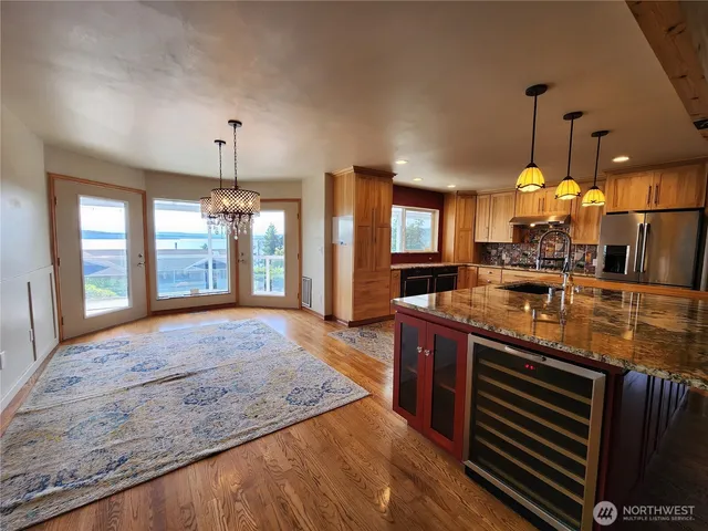 a large kitchen with granite countertop a sink and a stove