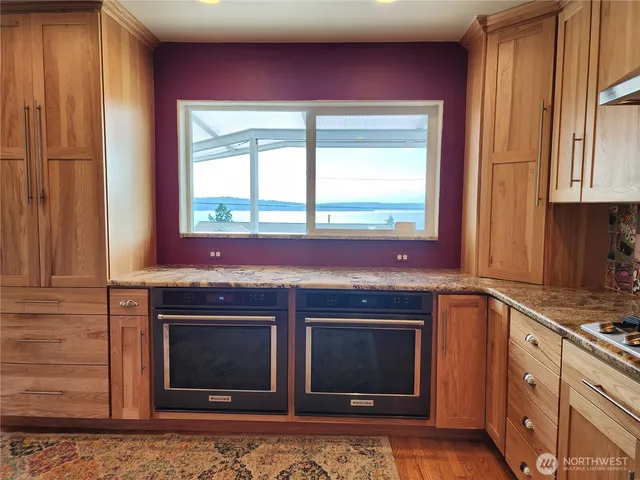 a stove top oven sitting inside of a kitchen
