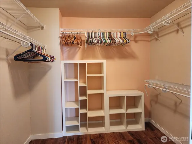 a view of walk in closet with empty racks