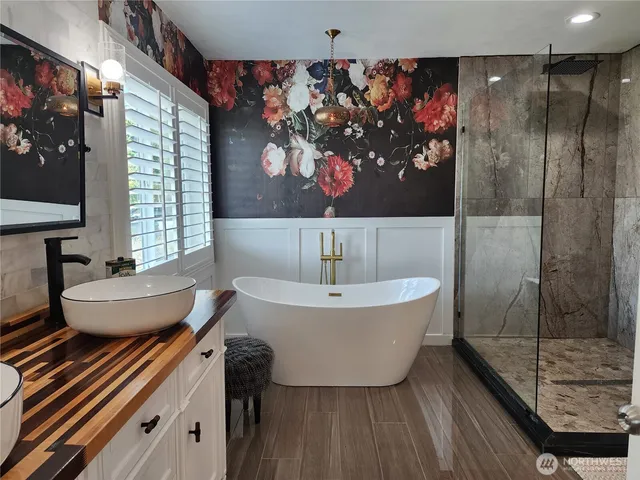a bathroom with a bathtub and a shower
