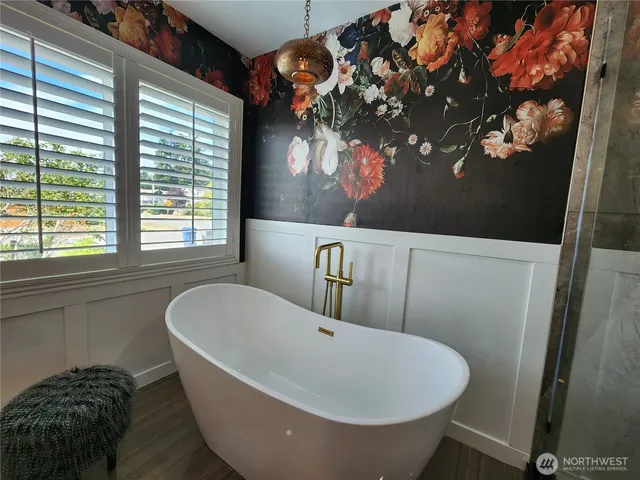 a bathroom with a bathtub and a window