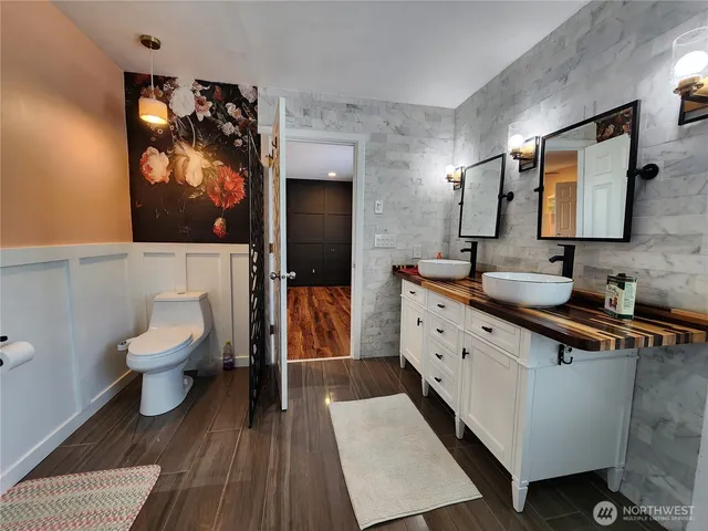 a spacious bathroom with a double vanity sink and a mirror