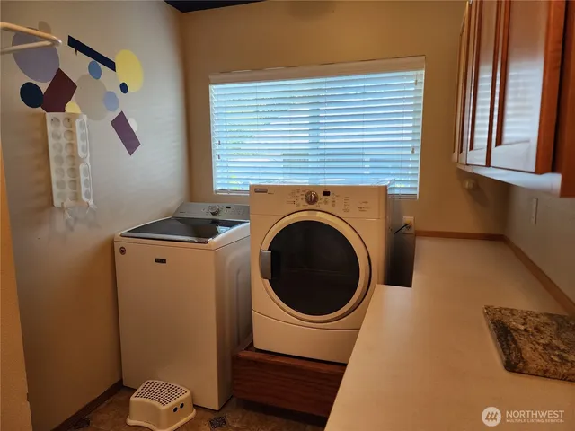 a close view of a utility room with dryer and washer