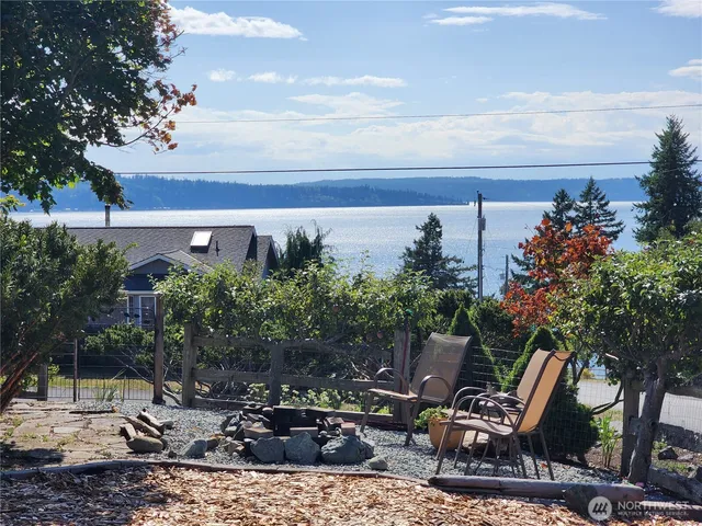 a view of backyard with a table and chairs and potted plants