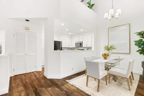 a kitchen with granite countertop a sink stainless steel appliances and cabinets