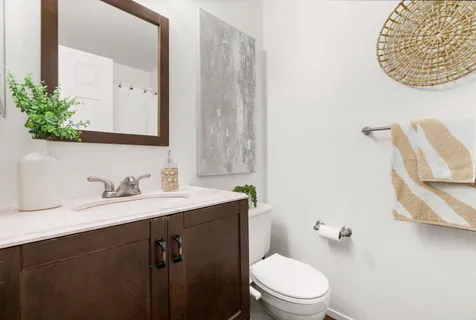 a bedroom with a bed and a potted plant