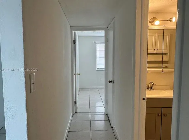 a view of a bathroom from a hallway