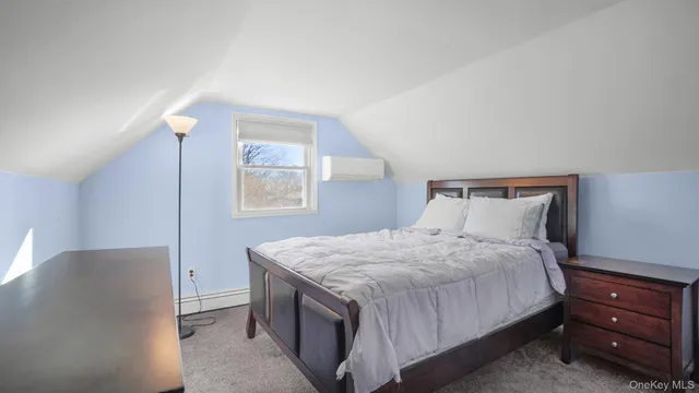 a bedroom with a bed and a night stand