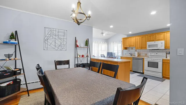 a kitchen with white cabinets and appliances