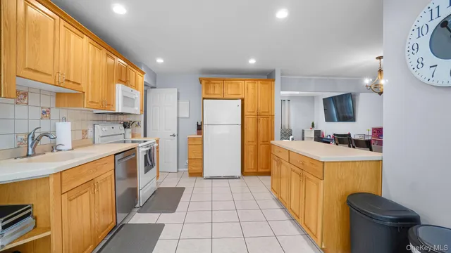 a kitchen with a sink and a stove top oven with wooden floor