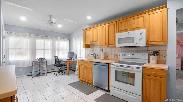 a kitchen with a stove a sink and a microwave