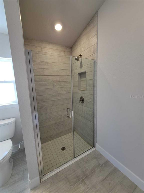 4465 Southwest 91st Ln Road Ocala, FL 34476 - Photo 19 of 42 a bathroom with a shower a toilet and sink