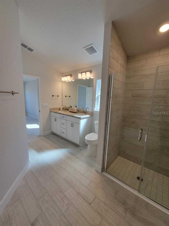 4465 Southwest 91st Ln Road Ocala, FL 34476 - Photo 20 of 42 a large bathroom with a glass door shower and sink