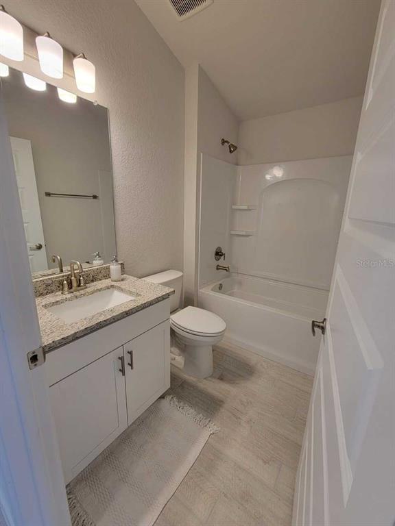 4465 Southwest 91st Ln Road Ocala, FL 34476 - Photo 26 of 42 a bathroom with a double vanity sink toilet mirror and shower
