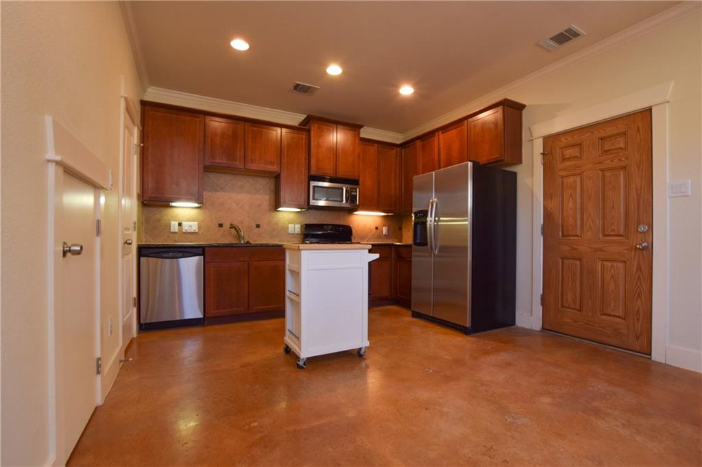 5405 Avenue H, Unit B Austin, TX 78751 - Photo 2 of 13 a kitchen with stainless steel appliances granite countertop a refrigerator a sink a stove a microwave and island
