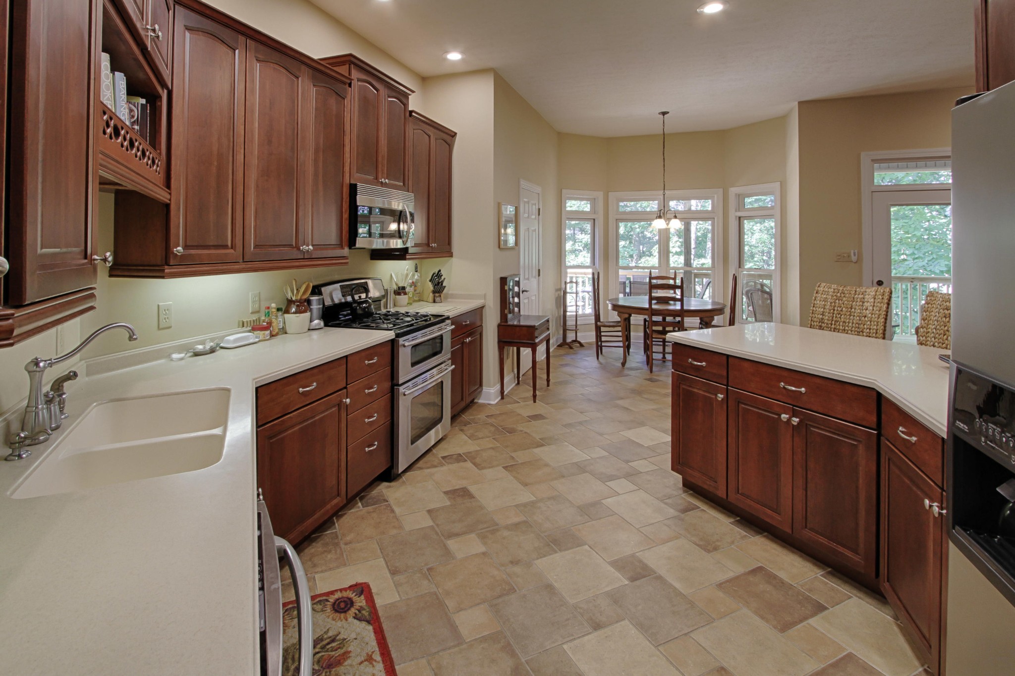 600 Baye Road Rutledge, TN 37861 - Photo 11 of 34 a kitchen with stainless steel appliances granite countertop wooden cabinets a stove top oven a sink and dishwasher