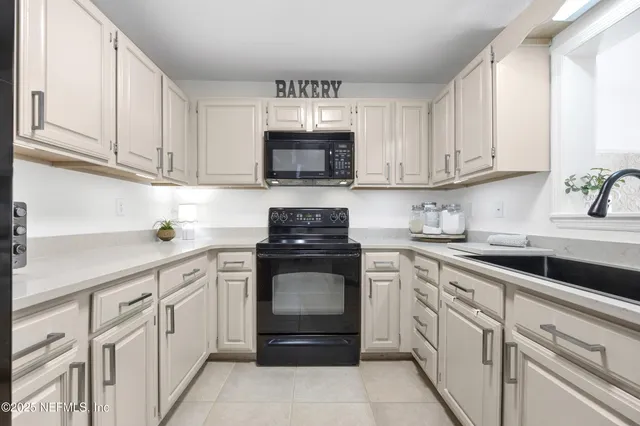 a kitchen with cabinets stainless steel appliances and a sink