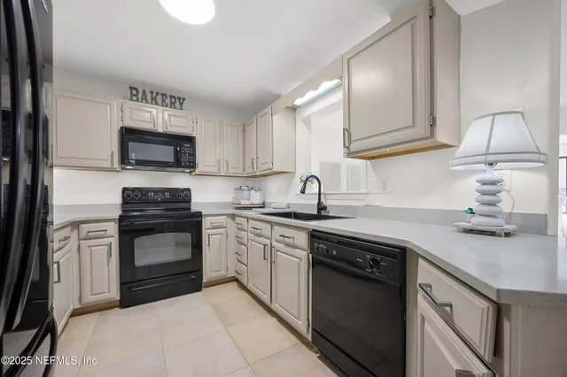 a kitchen with a sink stove and microwave