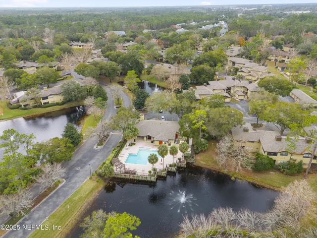 an aerial view of a house with a lake view