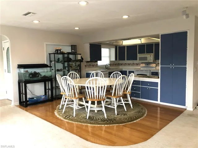 a room with furniture pool table and windows