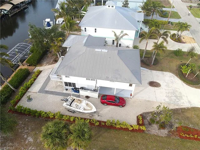 an aerial view of a house with swimming pool and patio