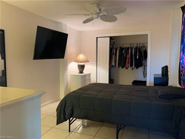 a front view of a house with a yard and lake view