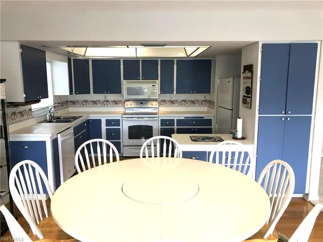 a kitchen with a white cabinets and white appliances