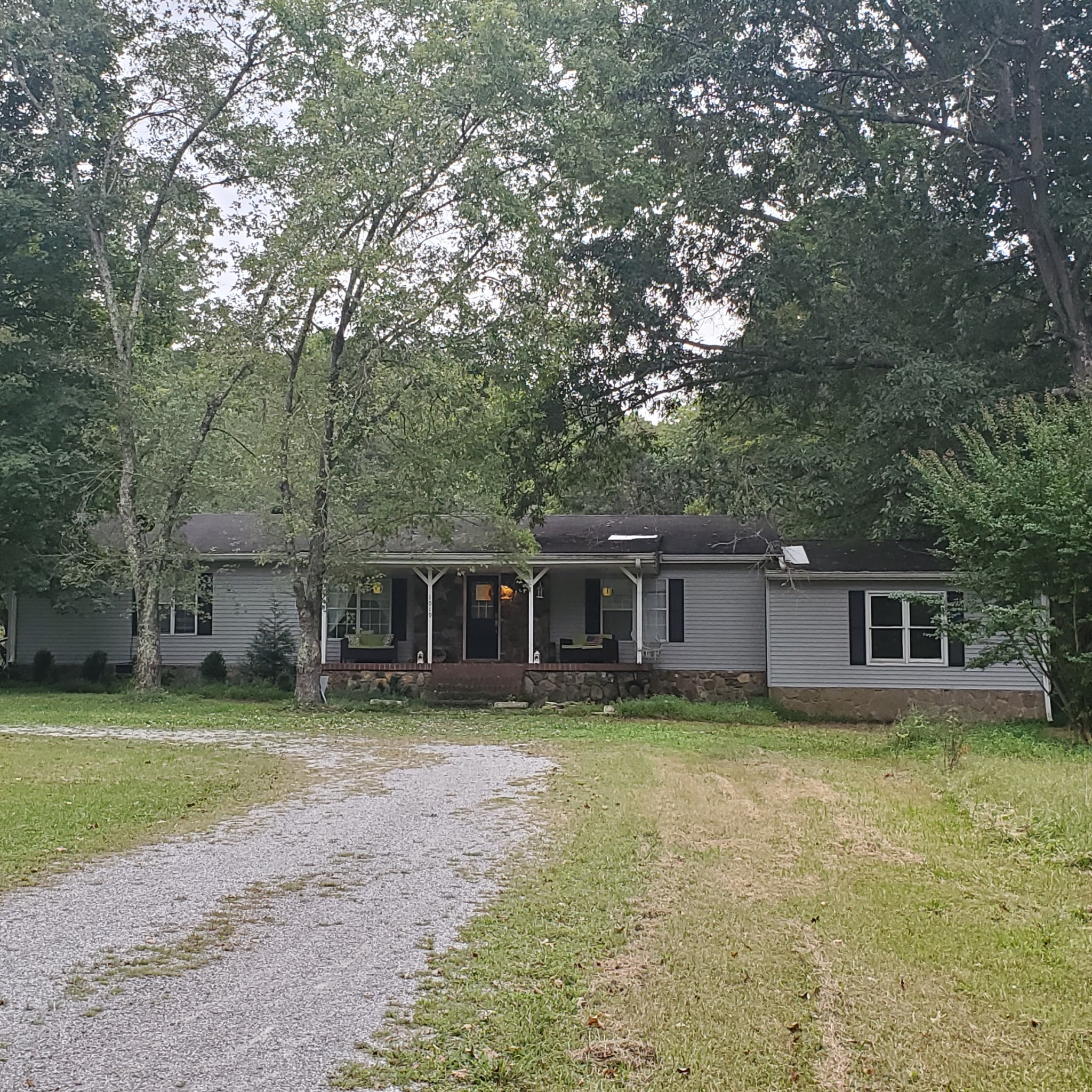 front view of a house with yard and trees