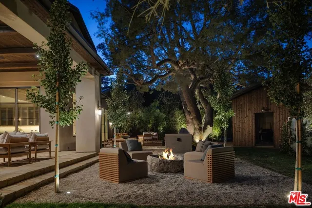 a view of a house with pool and sitting area