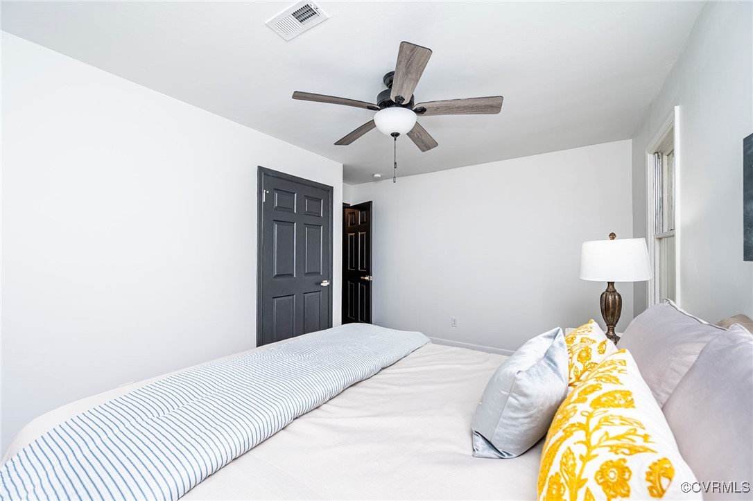 4117 Poplar Grove Road Midlothian, VA 23112 - Photo 17 of 31 a bedroom with a bed and a chandelier