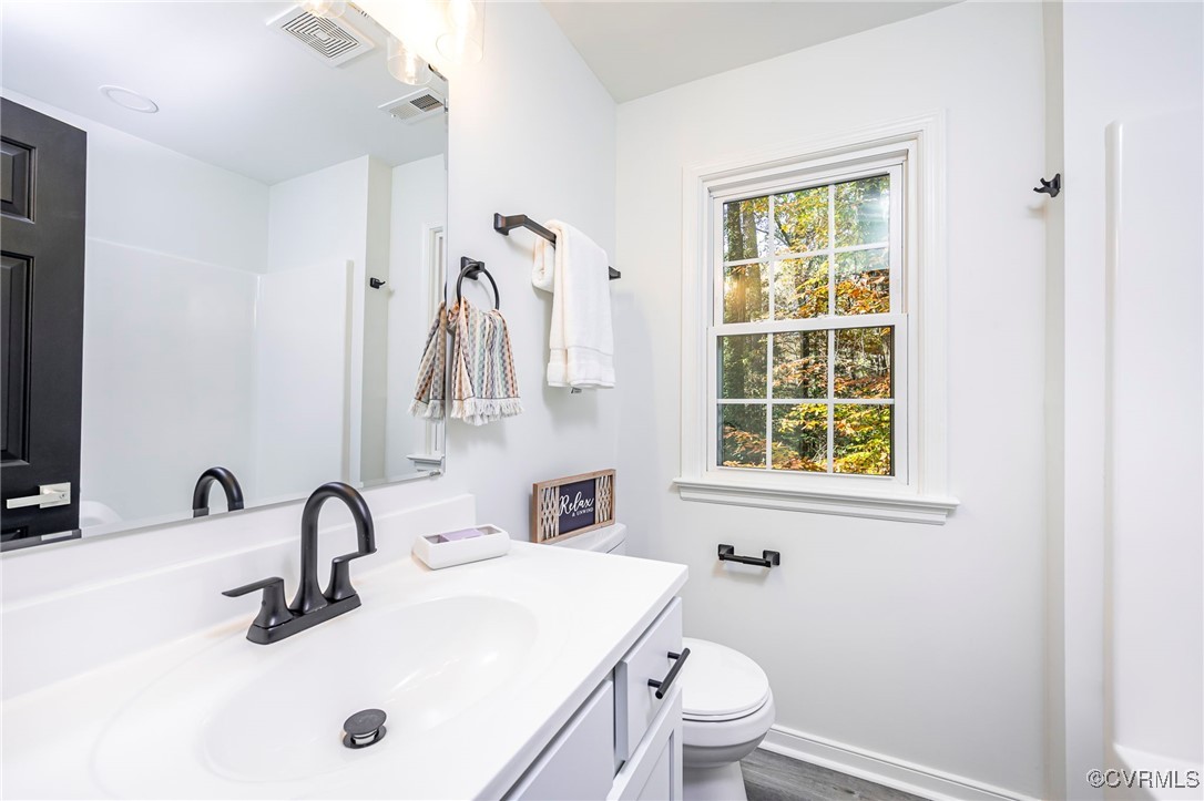 4117 Poplar Grove Road Midlothian, VA 23112 - Photo 20 of 31 a bathroom with a sink a toilet and a mirror
