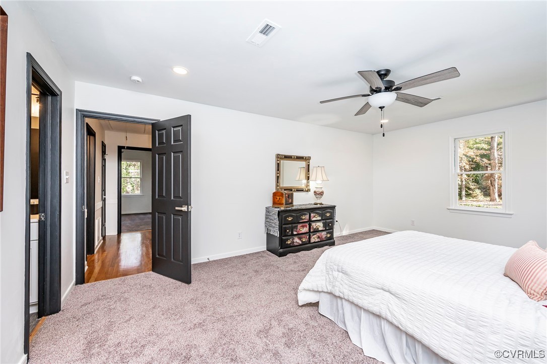 4117 Poplar Grove Road Midlothian, VA 23112 - Photo 23 of 31 a bedroom with a large bed and a chandelier