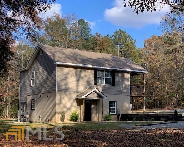 1404 Chappell Mill Road Jackson, GA 30233 - Photo 1 of 1 a front view of a house with a yard