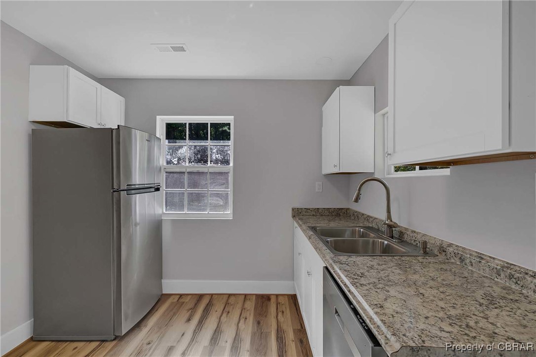 830 Glebe Road Mathews, VA 23109 - Photo 5 of 17 a kitchen with granite countertop a refrigerator and a sink