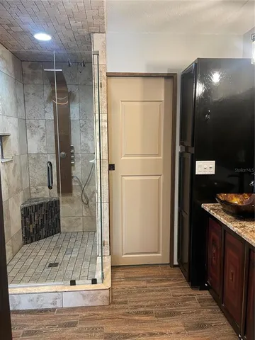 a bathroom with a shower and a sink