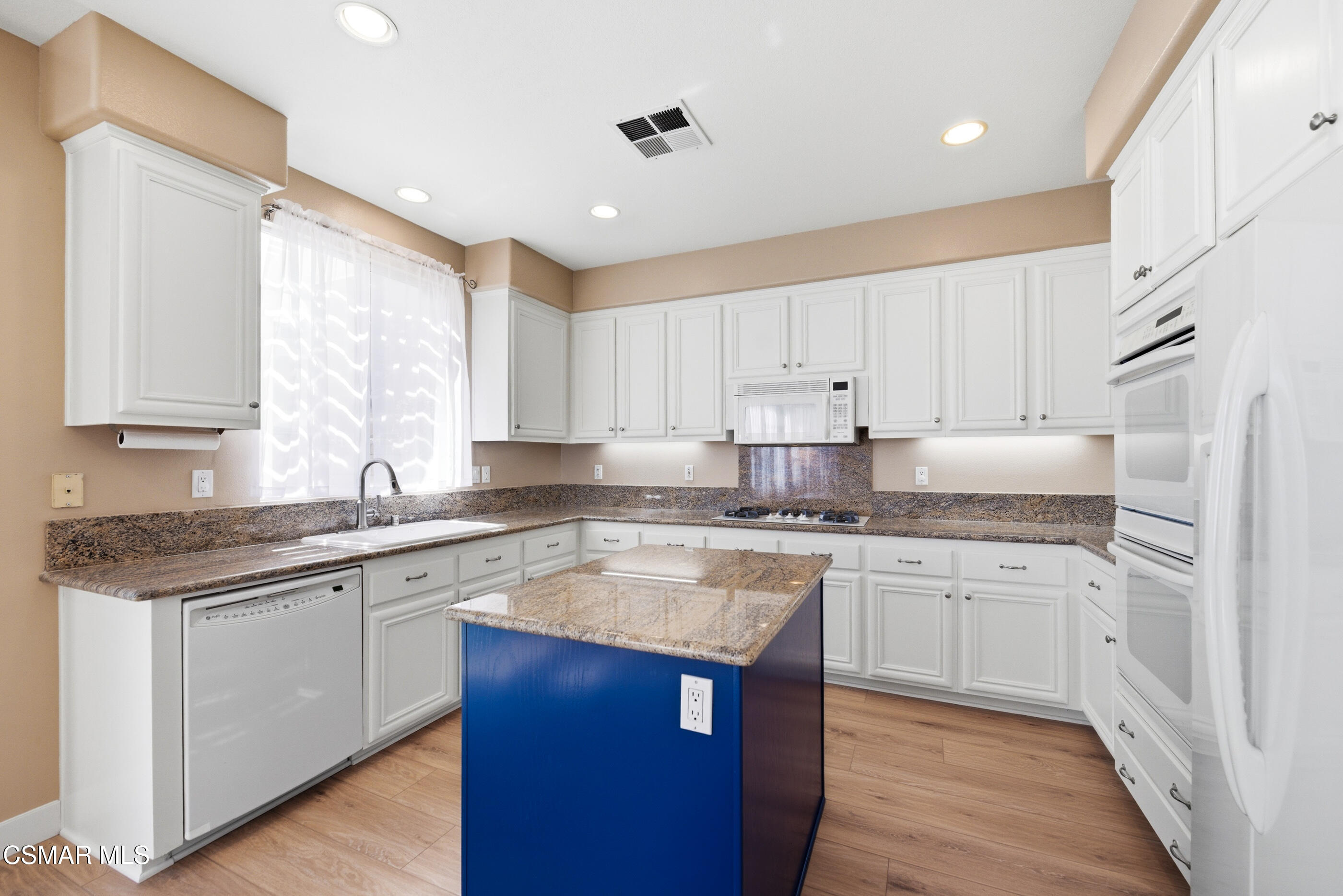 4884 Borders Street Simi Valley, CA 93063 - Photo 13 of 44 a kitchen with stainless steel appliances granite countertop a sink stove and refrigerator