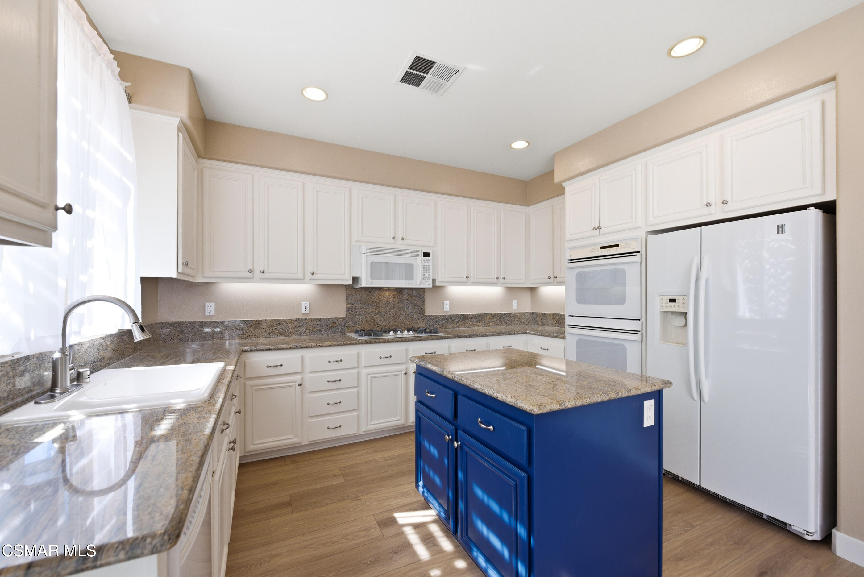 4884 Borders Street Simi Valley, CA 93063 - Photo 14 of 44 a kitchen with granite countertop a sink stove and refrigerator