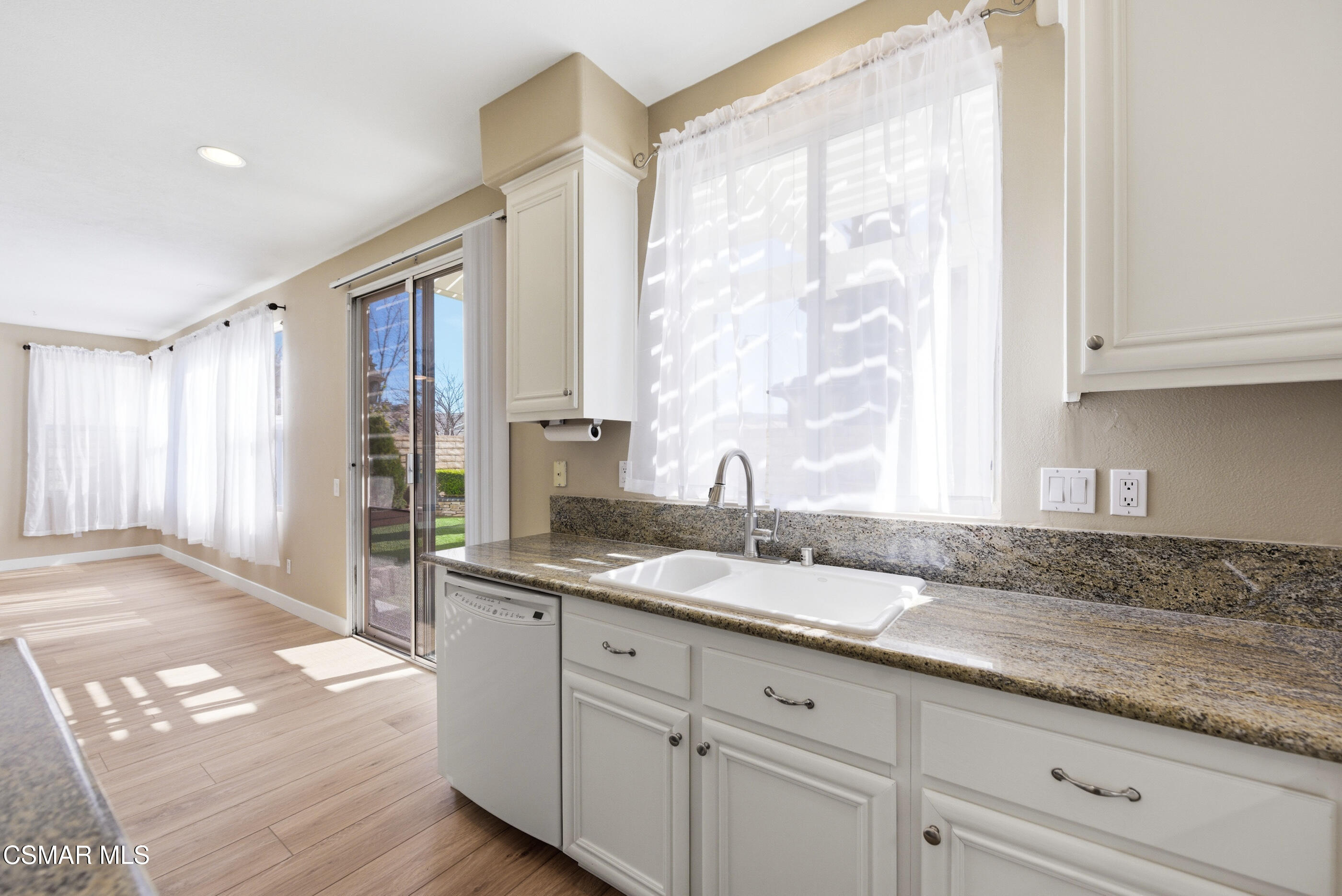 4884 Borders Street Simi Valley, CA 93063 - Photo 18 of 44 a kitchen with granite countertop a sink and a granite counter tops