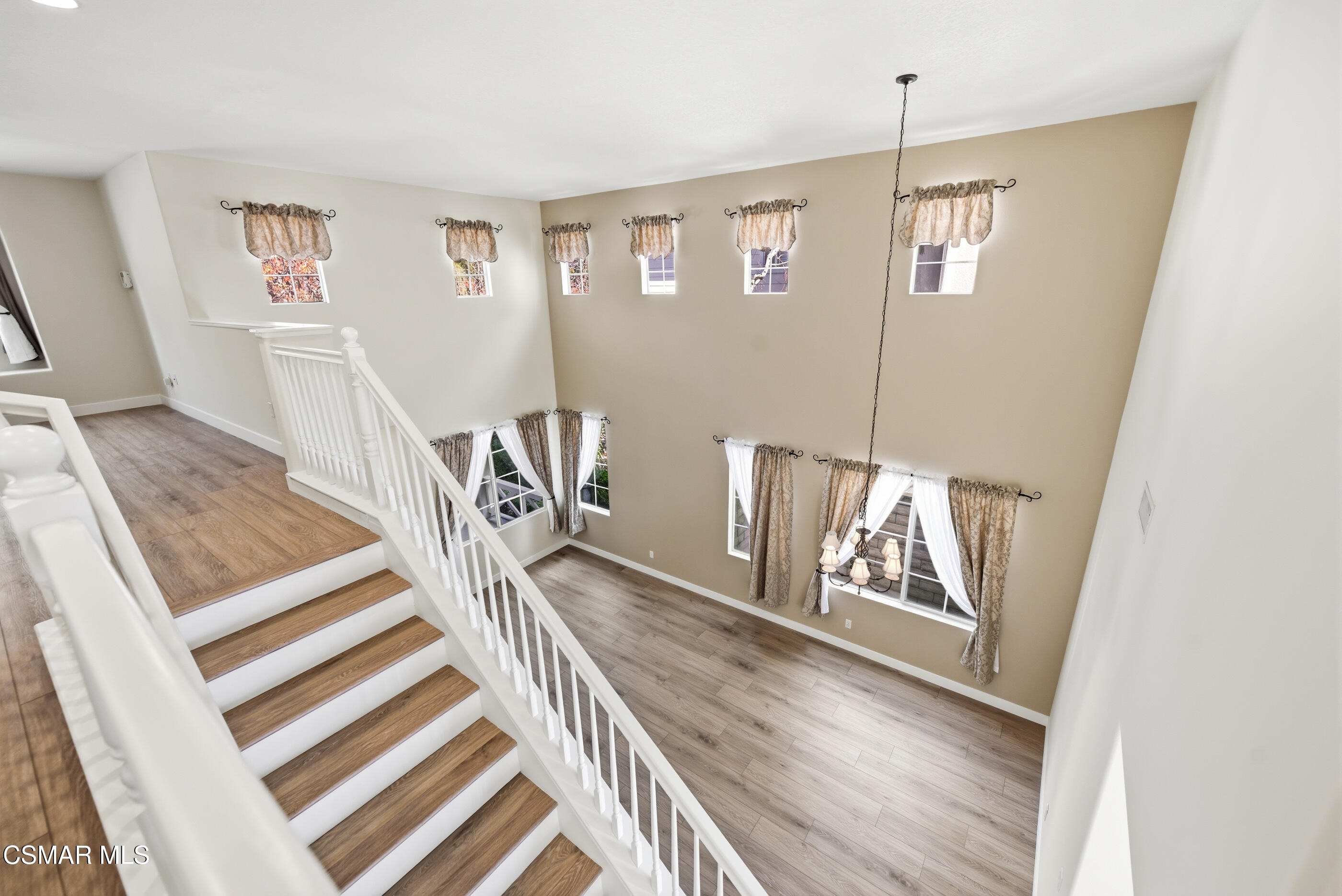 4884 Borders Street Simi Valley, CA 93063 - Photo 24 of 44 a view of a hallway with wooden floor