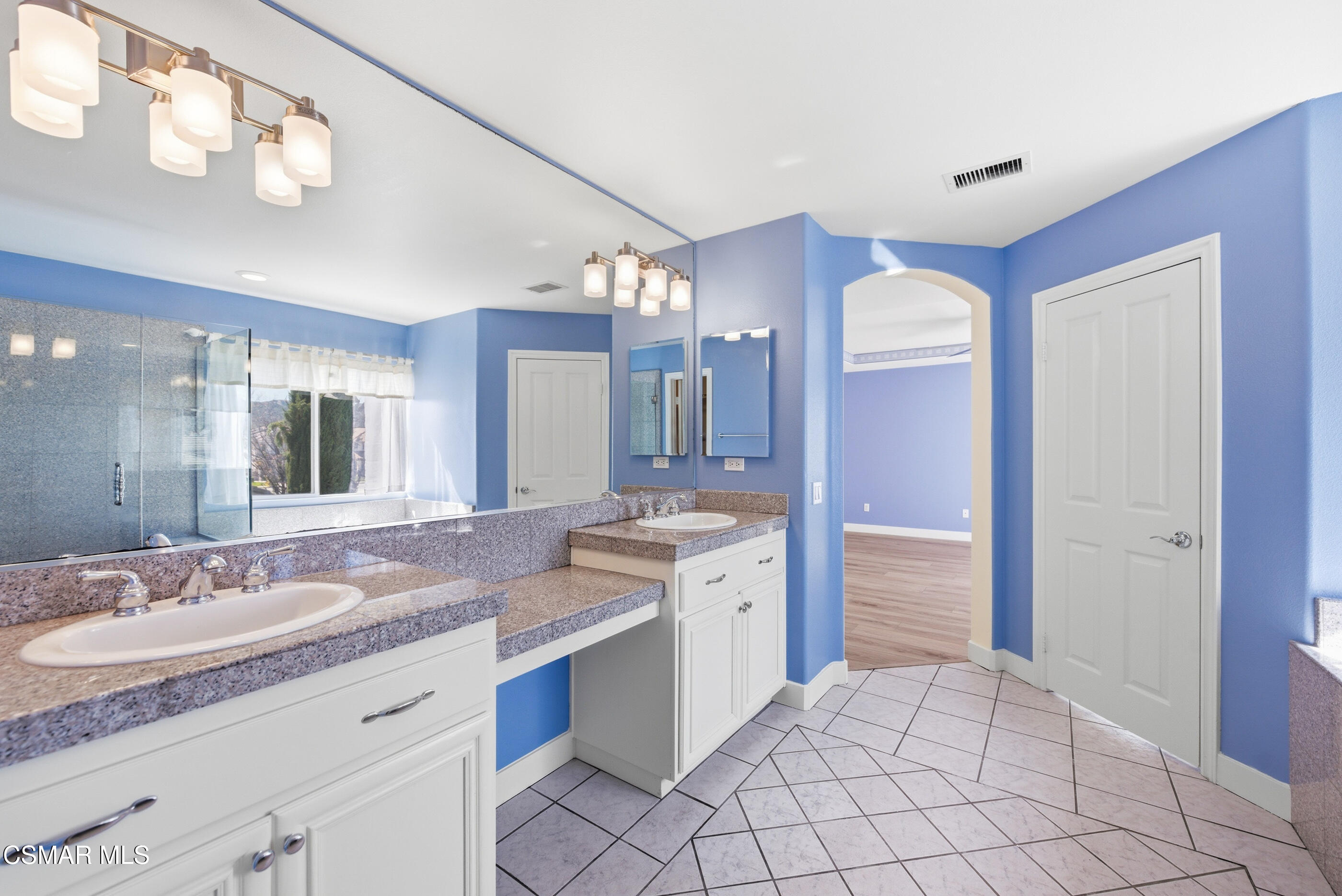 4884 Borders Street Simi Valley, CA 93063 - Photo 30 of 44 a bathroom with a granite countertop sink mirror and a shower
