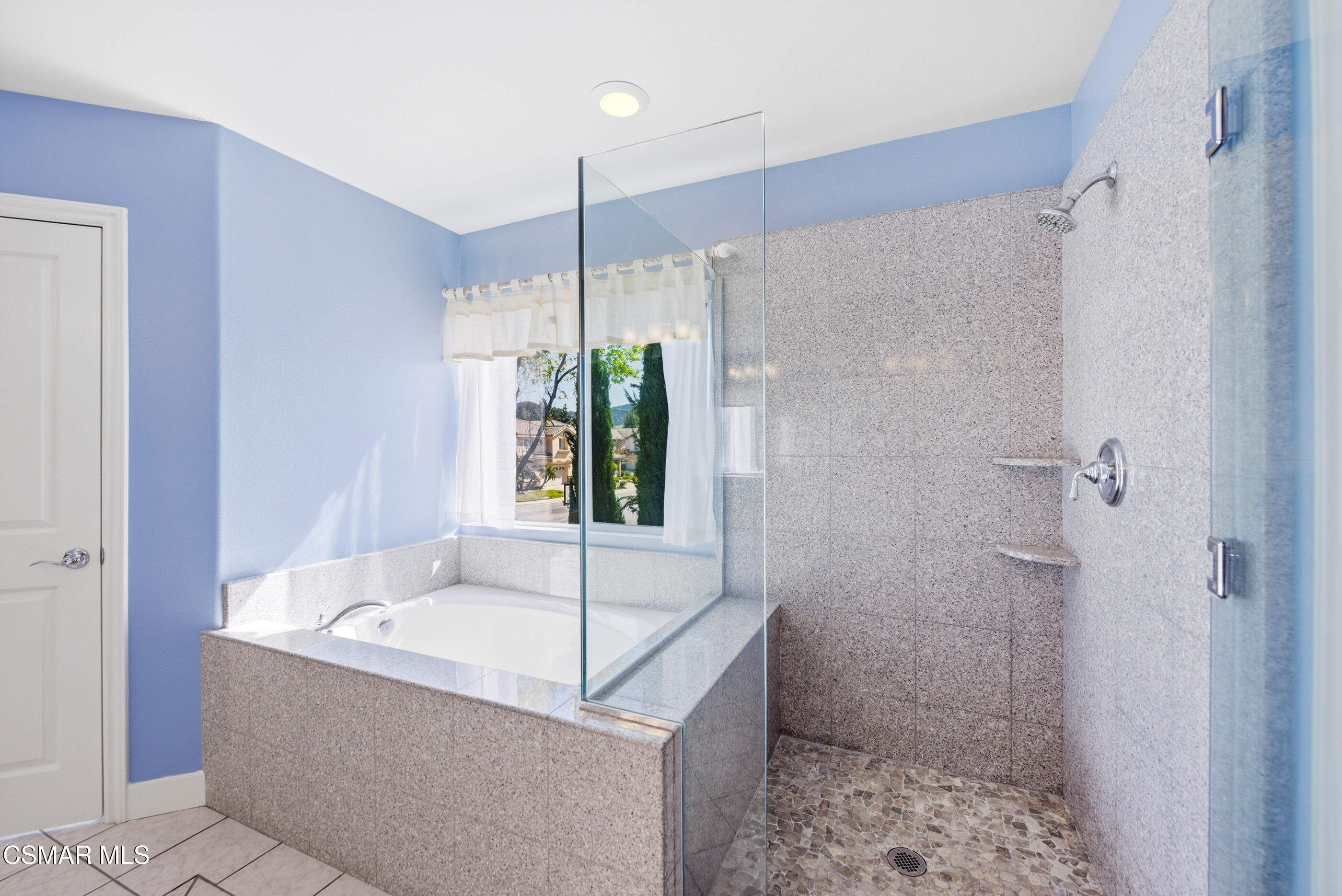 4884 Borders Street Simi Valley, CA 93063 - Photo 31 of 44 a bathroom with a tub shower and sink