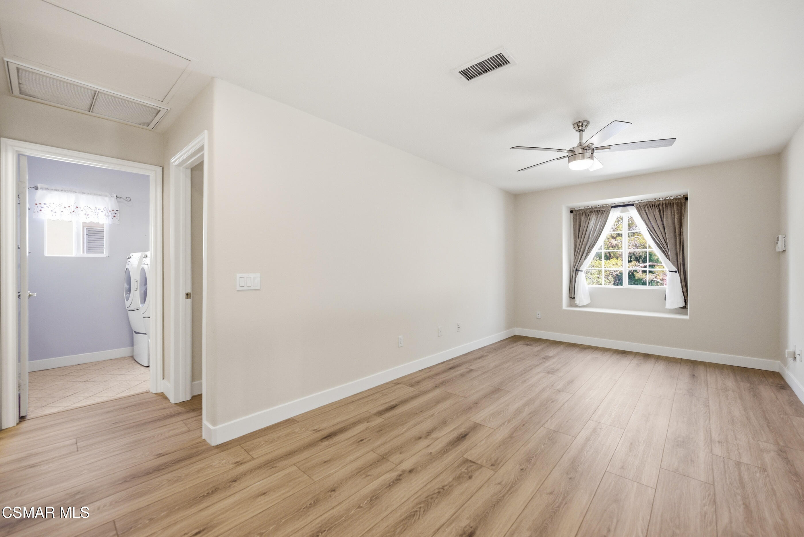 4884 Borders Street Simi Valley, CA 93063 - Photo 33 of 44 an empty room with wooden floor chandelier fan and windows