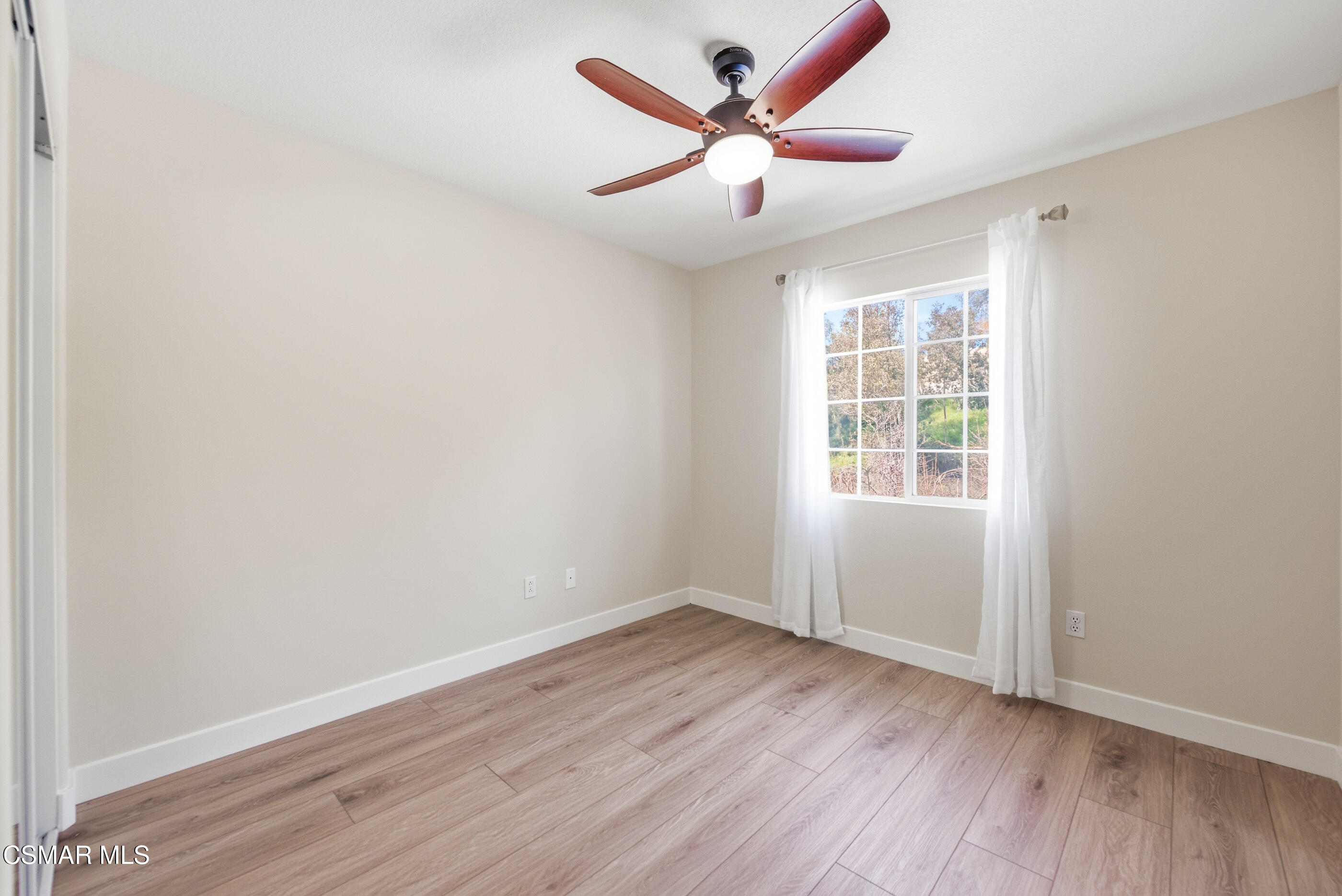 4884 Borders Street Simi Valley, CA 93063 - Photo 34 of 44 an empty room with wooden floor and windows
