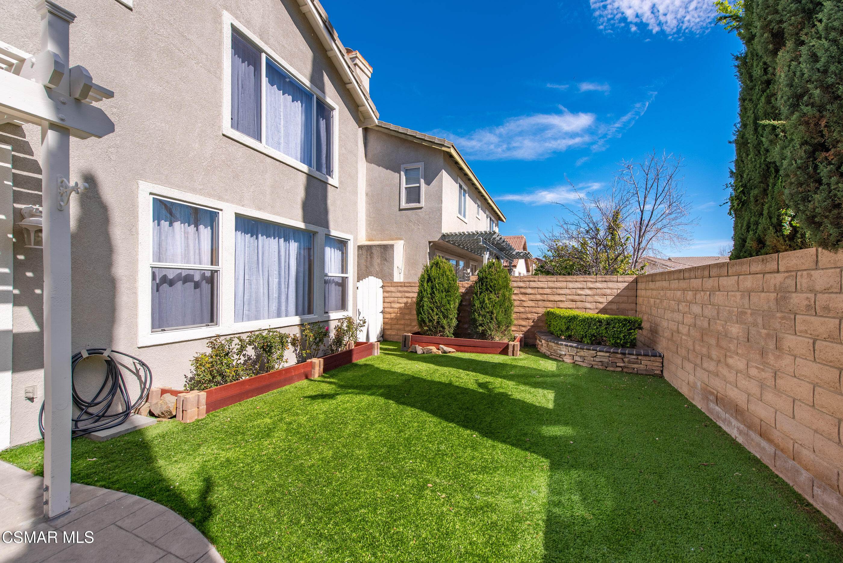 4884 Borders Street Simi Valley, CA 93063 - Photo 40 of 44 a front view of a house with a garden and yard