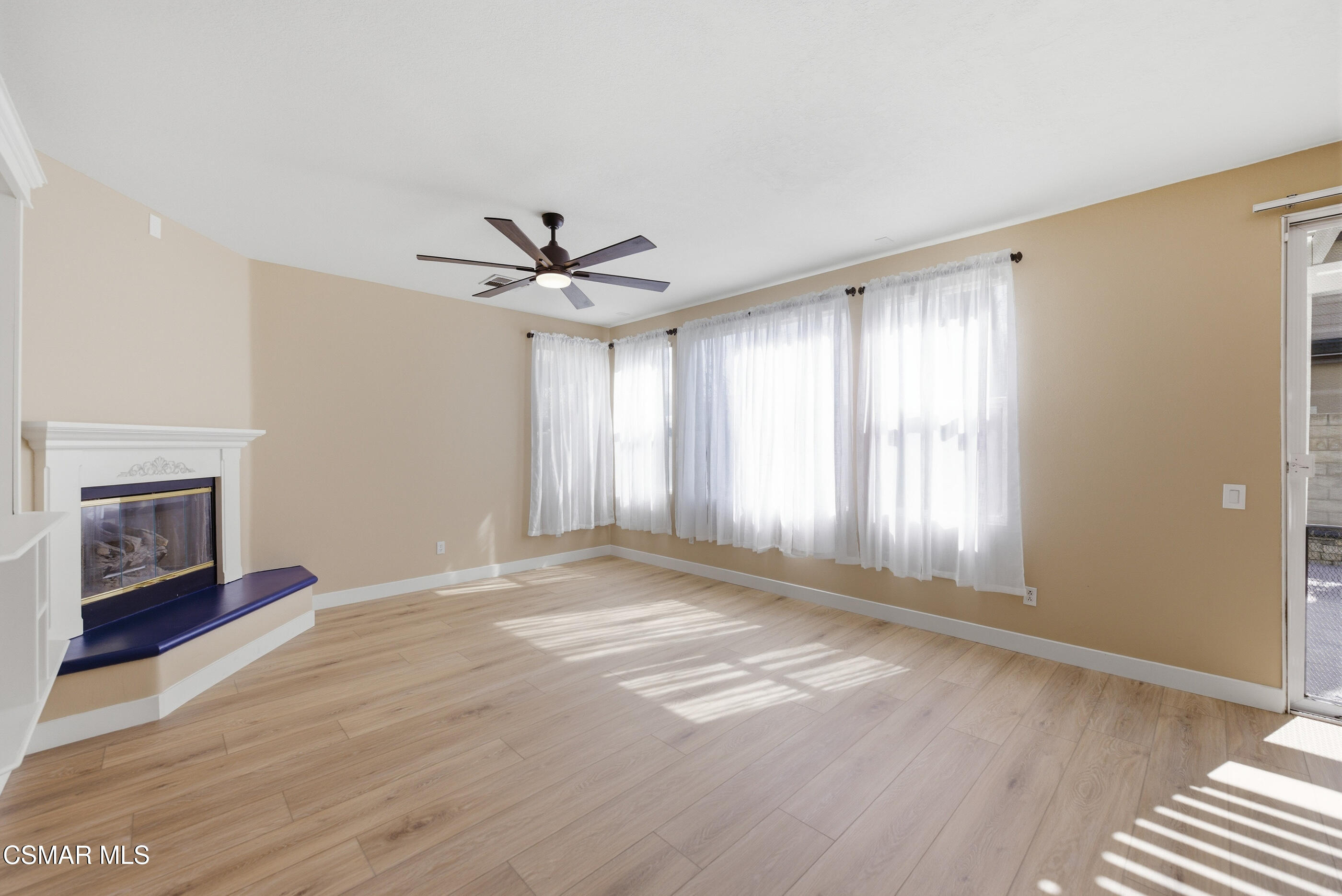 4884 Borders Street Simi Valley, CA 93063 - Photo 9 of 44 a view of an empty room with a window and a fireplace