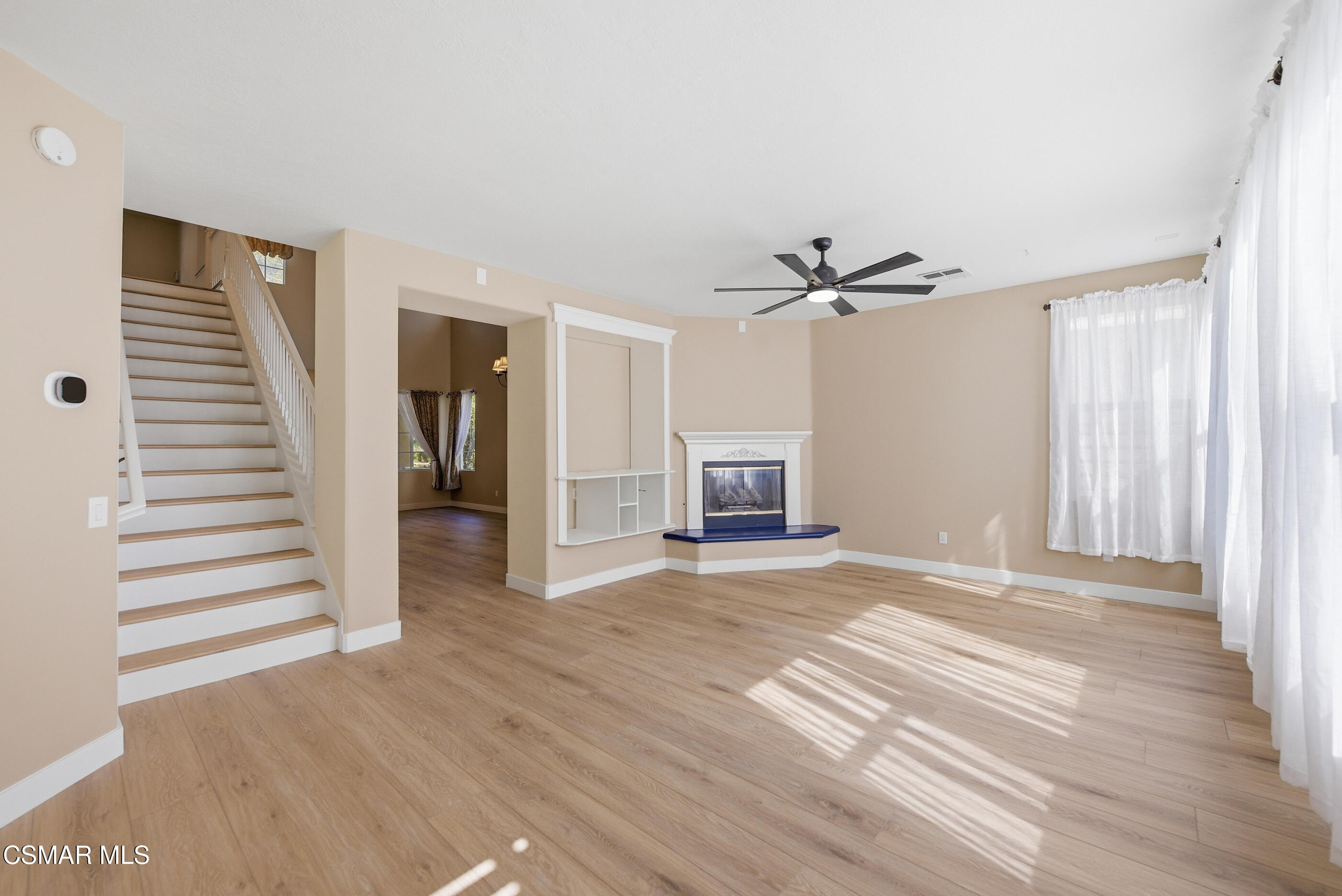 4884 Borders Street Simi Valley, CA 93063 - Photo 10 of 44 a view of a livingroom with wooden floor and a ceiling fan